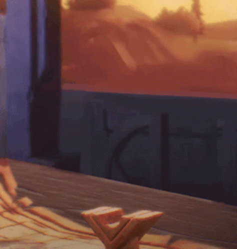 Person Sitting at Table by Window with Sunset