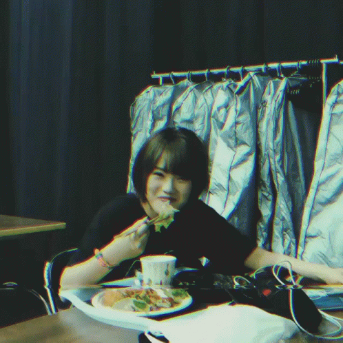 Person Sitting At Table With Plate Of Food GIF