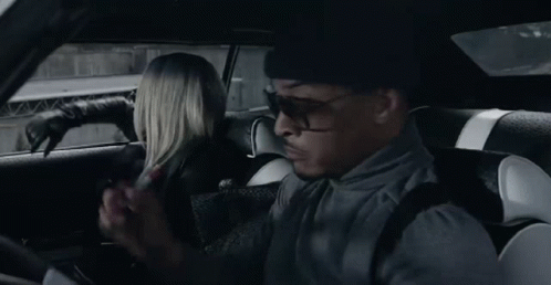 Person Sitting in Car Holding Paper