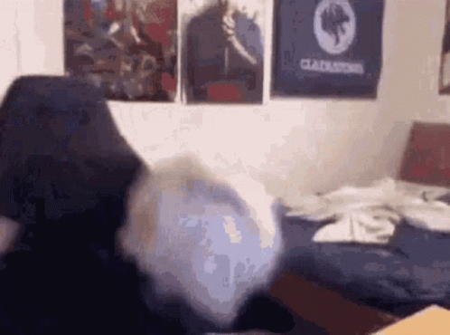Person Sitting on Bed with Gladiator Poster