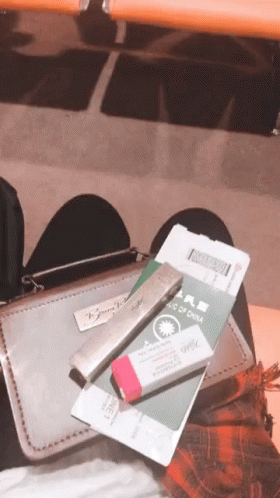 Person Sitting on Chair With Passport and Pencil