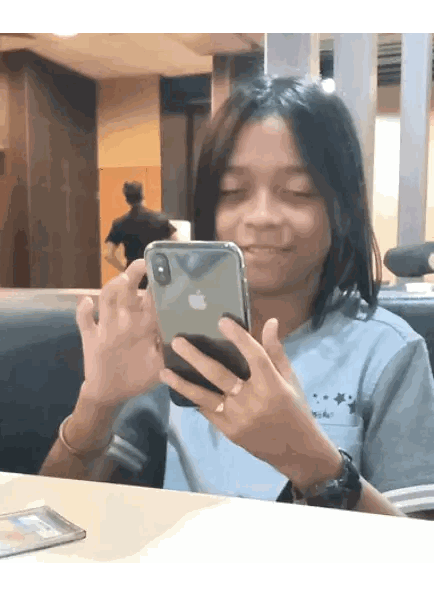 Person Sitting With Eyes Closed Holding iPhone