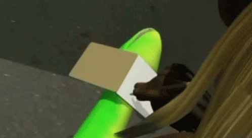 Person Sitting With Green Balloon And Cardboard Box GIF