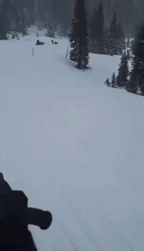Person Skiing Down Snowy Mountain