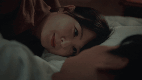 Person Sleeping In Bedroom With Desk And Lamp GIF