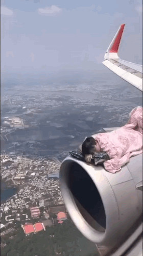 Person Sleeping on Airplane Wing