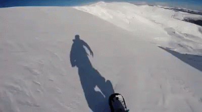 Person Snowboarding Down Snowy Hill