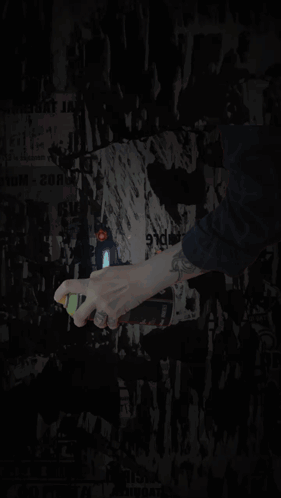 Person Spraying Paint on Wall With J-BL