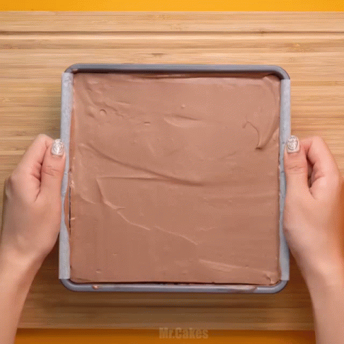 Person Spreading Chocolate Frosting