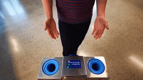 Person Standing Before Autoglove Machine
