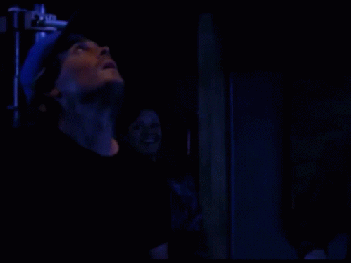 Person Standing in Dark Room with Blue Light