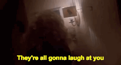 Person Standing in Dark Room With Laughing Words