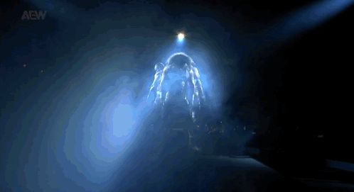 Person Standing in Dark Room With Light Shining
