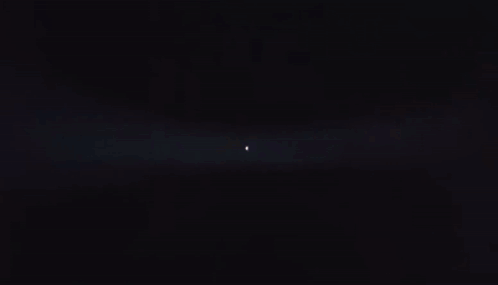 Person Standing in Dark Room With Light Shining