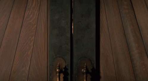Person Standing In Doorway With Light GIF