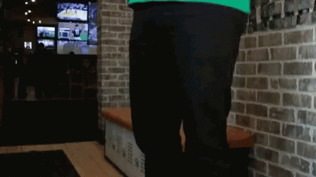 Person Standing In Front Of Brick Wall GIF