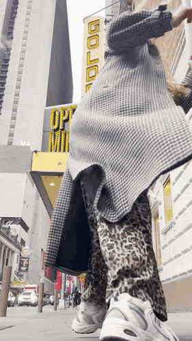 Person Standing In Front Of Building Saying Gold GIF