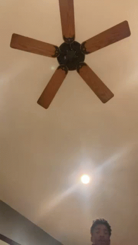 Person Standing in Front of Ceiling Fan