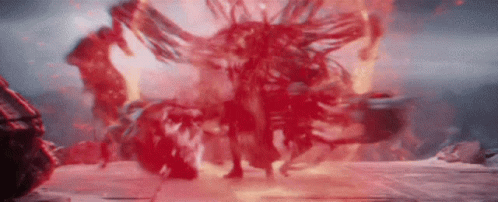 Person Standing in Front of Red Explosion