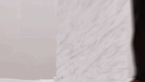 Person Standing in Front of White Wall