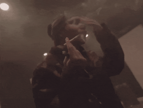 Person Standing In Room With Smoke Coming Out GIF
