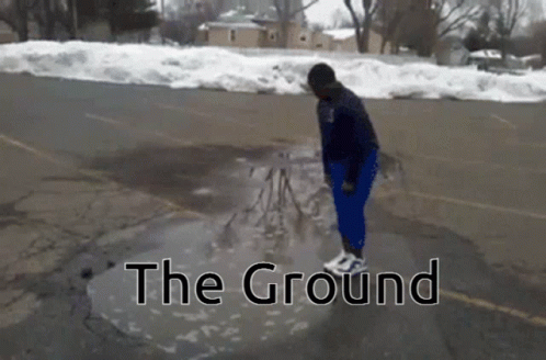 Person Standing in Water Puddle with Ground Text