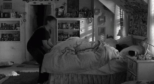 Person Standing Next to Bed