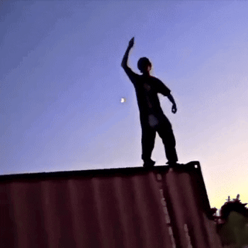Person Standing on Red Container