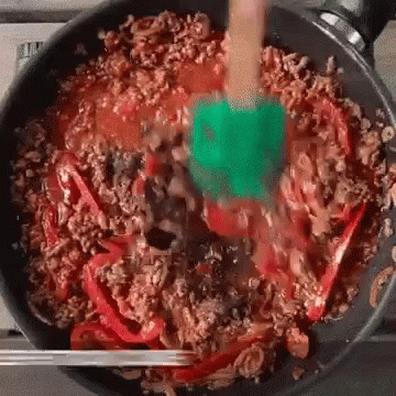 Person Stirring Food with Spatula