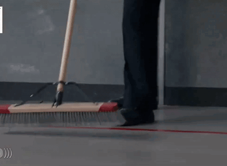Person Sweeping Floor With Broom