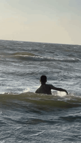 Person Swimming in Ocean with Arms Outstretched