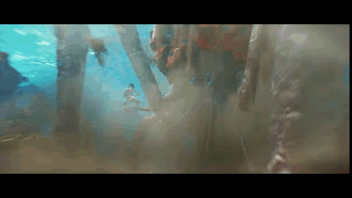 Person Swimming Underwater with Trees