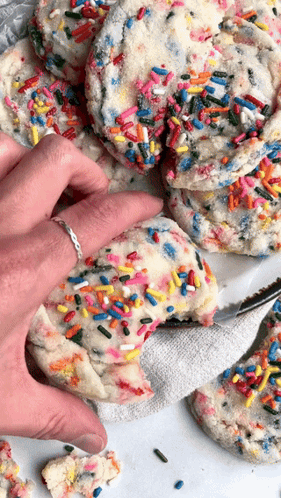Person Taking Bite of Cookie with Sprinkles