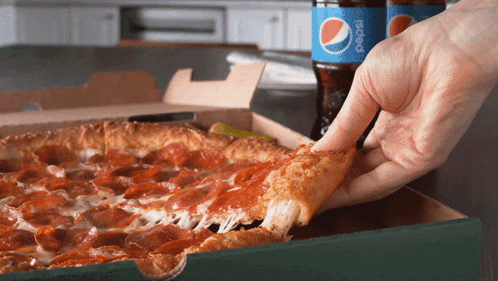 Person Taking Pepperoni Pizza Slice Beside Pepsi Bottle