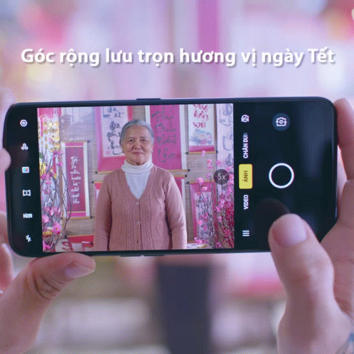 Person Taking Picture of Elderly Woman on Phone