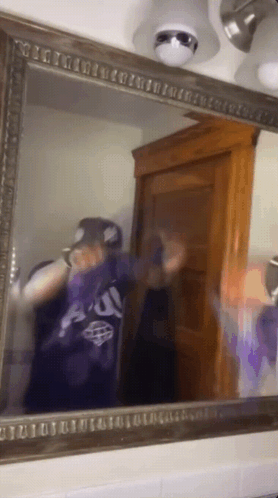 Person Taking Selfie in Mirror Wearing Au Shirt