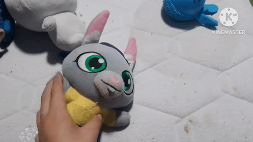 Person Touching Stuffed Animal With Yellow Shirt