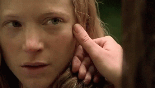 Person Touching Woman's Face With Finger GIF
