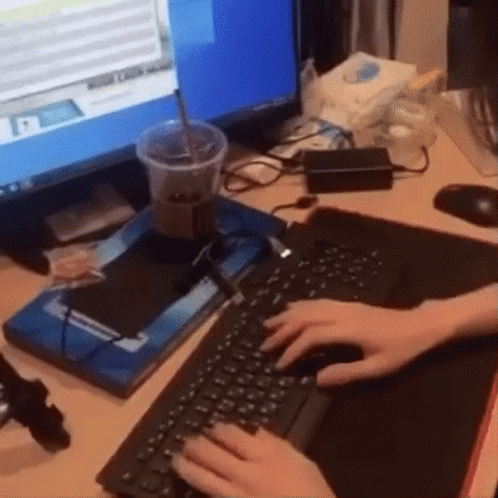 Person Typing on Keyboard at Computer Screen
