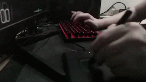 Person Typing on Keyboard in Front of Dual Settings Monitor