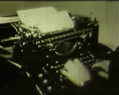 Person Typing On Old Typewriter With Paper GIF