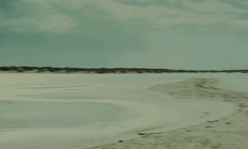 Person Walking Beach with Boat