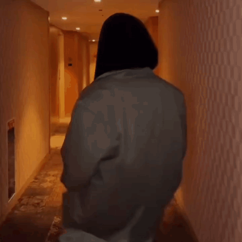 Person Walking Down Hallway