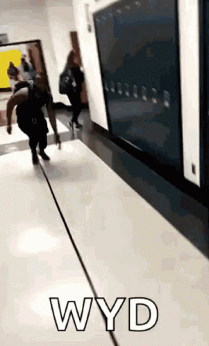 Person Walking Down Hallway Past Wyd
