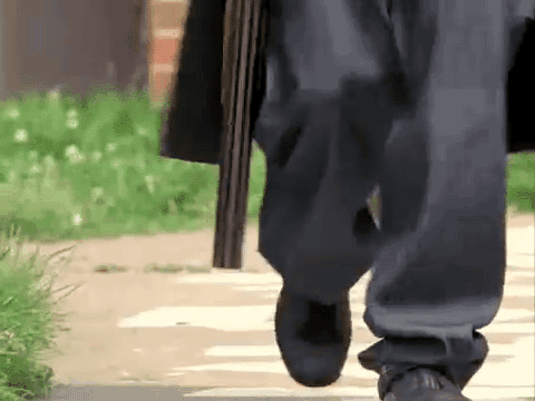 Person Walking Holding Shotgun
