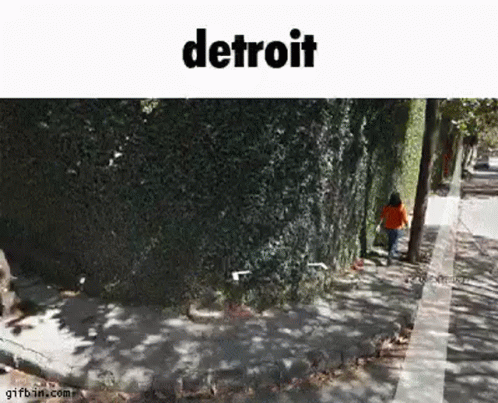 Person Walking Sidewalk Next to Tree
