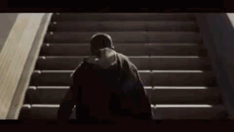 Person Walking Up Stairs With Hat