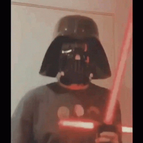 Person Wearing Darth Vader Mask Holding Lightsaber GIF