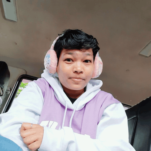 Person Wearing Ear Muffs and Purple Hoodie