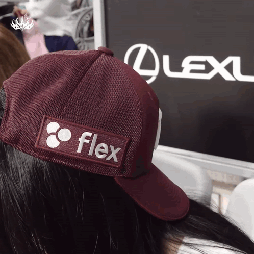 Person Wearing Flex Hat in Front of Lexus Sign